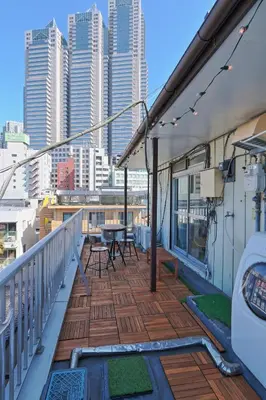 a balcony of a building with a table and chairs at V.Close to Nishi-Shinjuku/FrWIF/ Roof top Terrace in Tokyo
