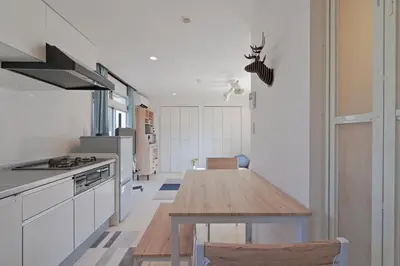 a kitchen with a wooden table in a room at V.Close to Nishi-Shinjuku/FrWIF/ Roof top Terrace in Tokyo