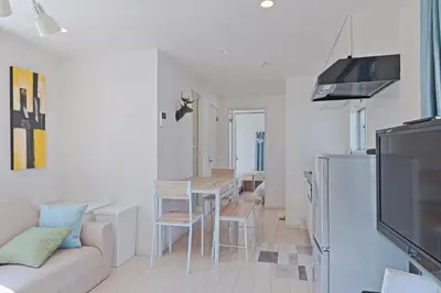 a kitchen and living room with a couch and a table at V.Close to Nishi-Shinjuku/FrWIF/ Roof top Terrace in Tokyo