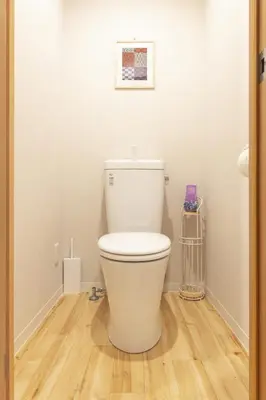 a white toilet in a bathroom with a wooden floor at SAKURA INN Asakusa station walking 4 Min Shinjuku Shibuya Ginza Oshiage in Tokyo