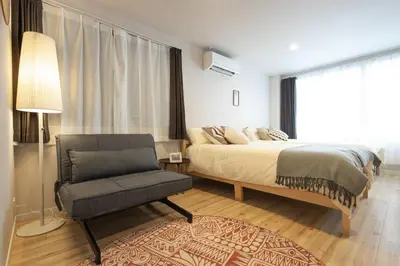 a bedroom with a bed and a chair and a window at SAKURA INN Asakusa station walking 4 Min Shinjuku Shibuya Ginza Oshiage in Tokyo