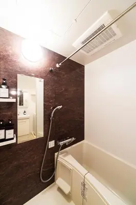a bathroom with a bath tub and a sink at GIVE Higashi Nakano in Tokyo