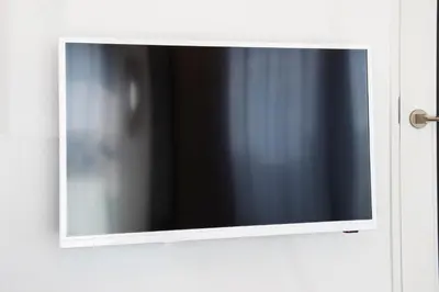 a mirror on a door with a television on it at GIVE Higashi Nakano in Tokyo