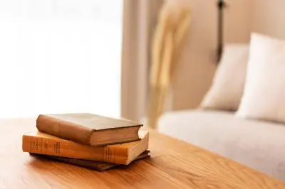 two books sitting on a table next to a bed at GIVE Higashi Nakano in Tokyo