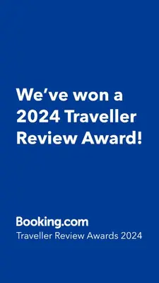 a blue sign that says weve won a traveler review award at \u6c60\u888b\u99c5\u307e\u3067\u5f92\u6b6915\u5206 \u7573\u306e\u5bb6 in Tokyo