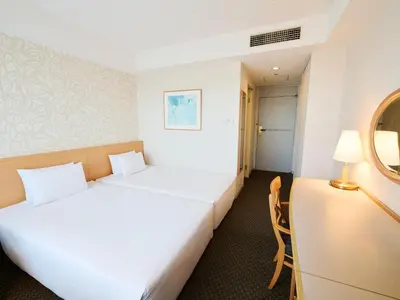 a hotel room with a bed and a chair at Tobu Hotel Levant Tokyo in Tokyo