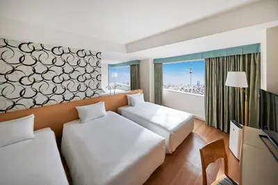 a hotel room with two beds and a television at Tobu Hotel Levant Tokyo in Tokyo