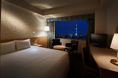 a hotel room with a bed and a desk with a television at Tobu Hotel Levant Tokyo in Tokyo