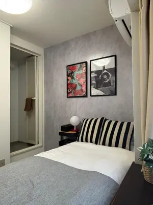 a bedroom with a bed and three pictures on the wall at Fact Dream House \u65b0\u5bbf\u4e09\u4e01\u76ee\u5f92\u6b693\u5206\u8272\u3005\u63c3\u3046\u30ef\u30f3\u30eb\u30fc\u30e0 in Tokyo
