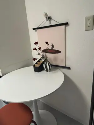 a white table and a white table and a picture at Fact Dream House \u65b0\u5bbf\u4e09\u4e01\u76ee\u5f92\u6b693\u5206\u8272\u3005\u63c3\u3046\u30ef\u30f3\u30eb\u30fc\u30e0 in Tokyo