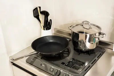 a pan on top of a stove with a pot at GIVE Araiyakushi in Tokyo