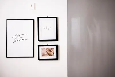 a group of four framed pictures on a wall at GIVE Araiyakushi in Tokyo