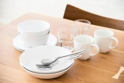 a table with white plates and silverware on it at GIVE Araiyakushi in Tokyo