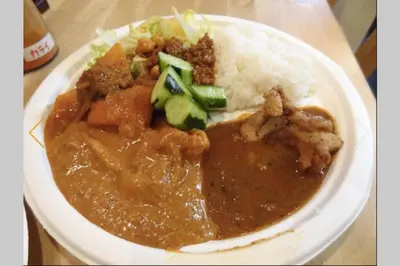 a plate of food with meat and rice and vegetables at Dwell Urban 6C in Tokyo
