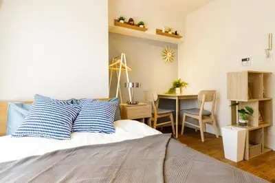 a bedroom with a bed and a desk and a table at Dwell Urban 4C in Tokyo