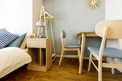 a bedroom with a bed and a desk and chairs at Dwell Urban 4C in Tokyo