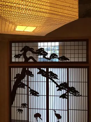 a window with a bunch of birds in a cage at Shibuya神宮前 DAICHI&SOTEN in Tokyo