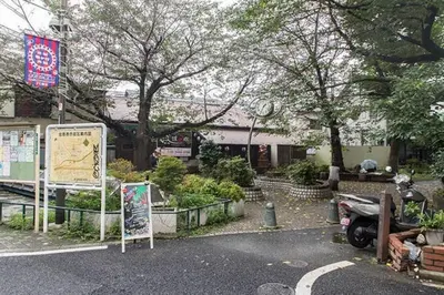 a parking lot with a sign in front of a building at Dwell Urban 2B in Tokyo