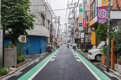 an empty street in a city with buildings at Dwell Urban 7C in Tokyo