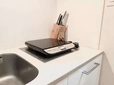 a cell phone sitting on a counter next to a sink at Dwell Urban 7D in Tokyo