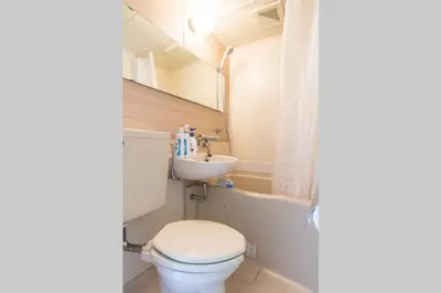 a bathroom with a toilet and a sink at Dwell Urban 7D in Tokyo