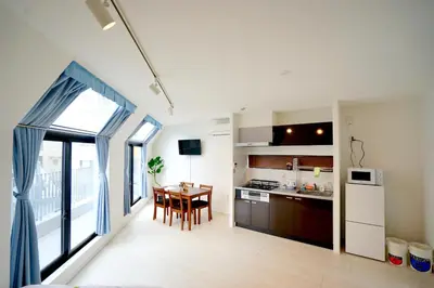 a kitchen and dining room with a table and a window at Court Residence Tokyo Nakano in Tokyo