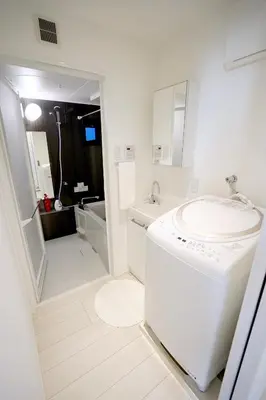 a white bathroom with a sink and a washing machine at Court Residence Tokyo Nakano in Tokyo