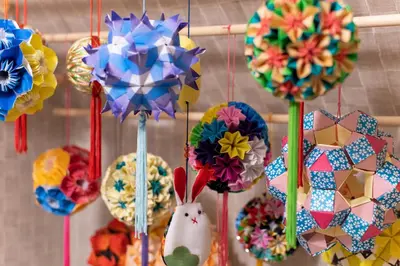 a bunch of paper flowers hanging on a wall at CuteFamilyHouse! 3LDK 6minShinjuku 3minJRsta Cozy,Fun,Bright! KidsFree Under6yrs in Tokyo