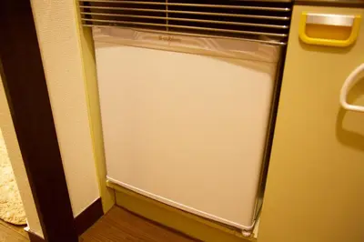 a small white refrigerator in a room with a window at Akasaka Koyu Building 801 in Tokyo