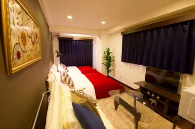 a bedroom with a bed with a red blanket at Akasaka Koyu Building 801 in Tokyo