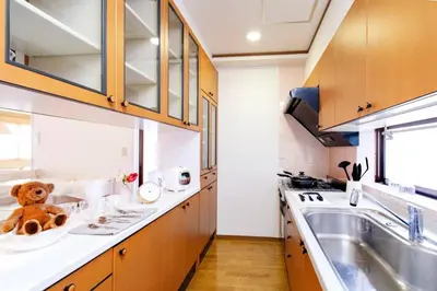 a small kitchen with a teddy bear sitting on the counter at HARMONIA\u6771\u4eac\u5800\u5207 10\u540d\u5b9a\u54e190\u5e73\u7c73\u306e\u5e83\u3044Condominium in Tokyo