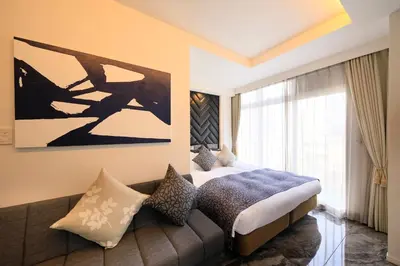 a hotel room with a bed and a couch at Centurion Hotel Residential Akasaka Station in Tokyo