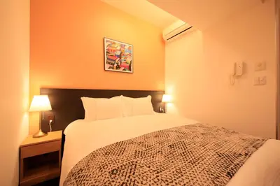 a bedroom with a large bed in a room at Centurion Hotel Residential Akasaka Station in Tokyo
