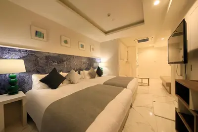 a hotel room with two beds and a television at Centurion Hotel Residential Akasaka Station in Tokyo
