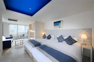 a bedroom with a large bed with a blue ceiling at Centurion Hotel Residential Akasaka Station in Tokyo