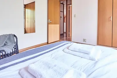 a bed with white towels on it in a room at Villa Shibuya in Tokyo