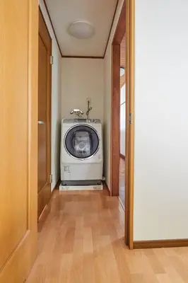 a door to a room with a microwave in a hallway at Villa Shibuya in Tokyo