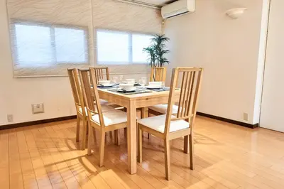 a dining room table and chairs in a room at Villa Shibuya in Tokyo