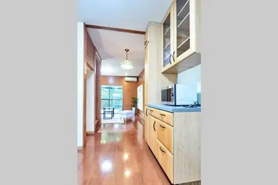 a kitchen with wooden cabinets and a microwave at Annex Shibuya in Tokyo