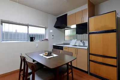 a kitchen with a wooden table and a kitchen with a sink at Annex Shibuya in Tokyo