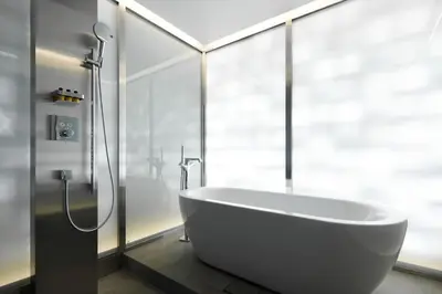 a white bath tub in a bathroom with a shower at Aloft Tokyo Ginza in Tokyo
