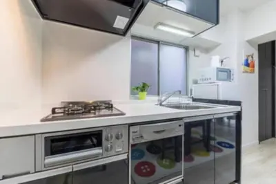 a kitchen with a sink and a stove at HAMAMATSUCHO Mansion #2DK# Minato-ku in Tokyo