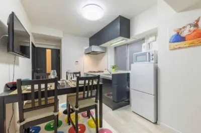 a kitchen with a table and chairs and a refrigerator at HAMAMATSUCHO Mansion #2DK# Minato-ku in Tokyo