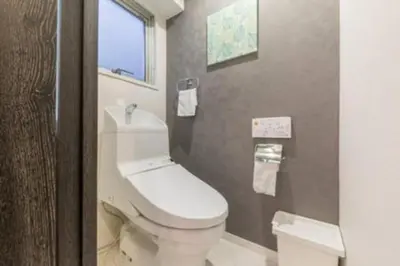 a bathroom with a white toilet and a window at HAMAMATSUCHO Mansion #2DK# Minato-ku in Tokyo