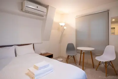 a bedroom with a bed and a table and chairs at 3-40-8 / Vacation STAY 77973 in Tokyo