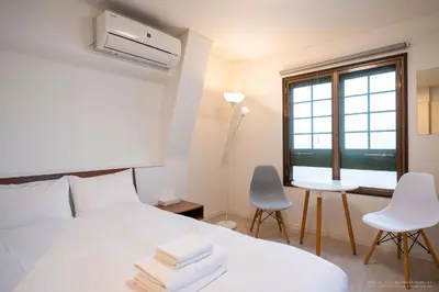 a bedroom with a bed and a desk and a window at 3-40-8 / Vacation STAY 77973 in Tokyo