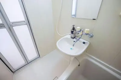 a white bathroom with a sink and a mirror at 3-40-8 / Vacation STAY 77973 in Tokyo