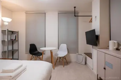 a bedroom with a bed and two chairs and a table at 3-40-8 / Vacation STAY 77968 in Tokyo
