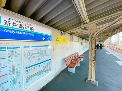 a train station with benches and posters on the wall at 3-40-8 / Vacation STAY 77971 in Tokyo