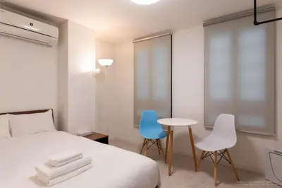 a bedroom with a bed and two chairs and a table at 3-40-8 / Vacation STAY 77971 in Tokyo